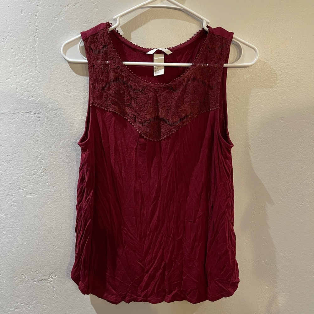 Maroon top with design. Size Medium